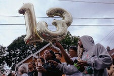 Residents carried balloons representing the age of Nyah Mway during a vigil.