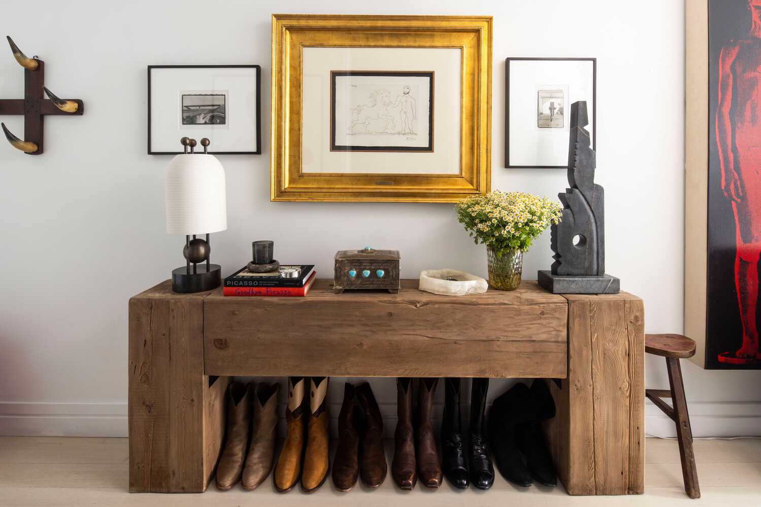 A row of Lucchese Western boots await visitors at the entry to Andrew Torrey’s home, one of many nods to his upbringing on a farm.