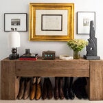 A row of Lucchese Western boots await visitors at the entry to Andrew Torrey’s home, one of many nods to his upbringing on a farm.