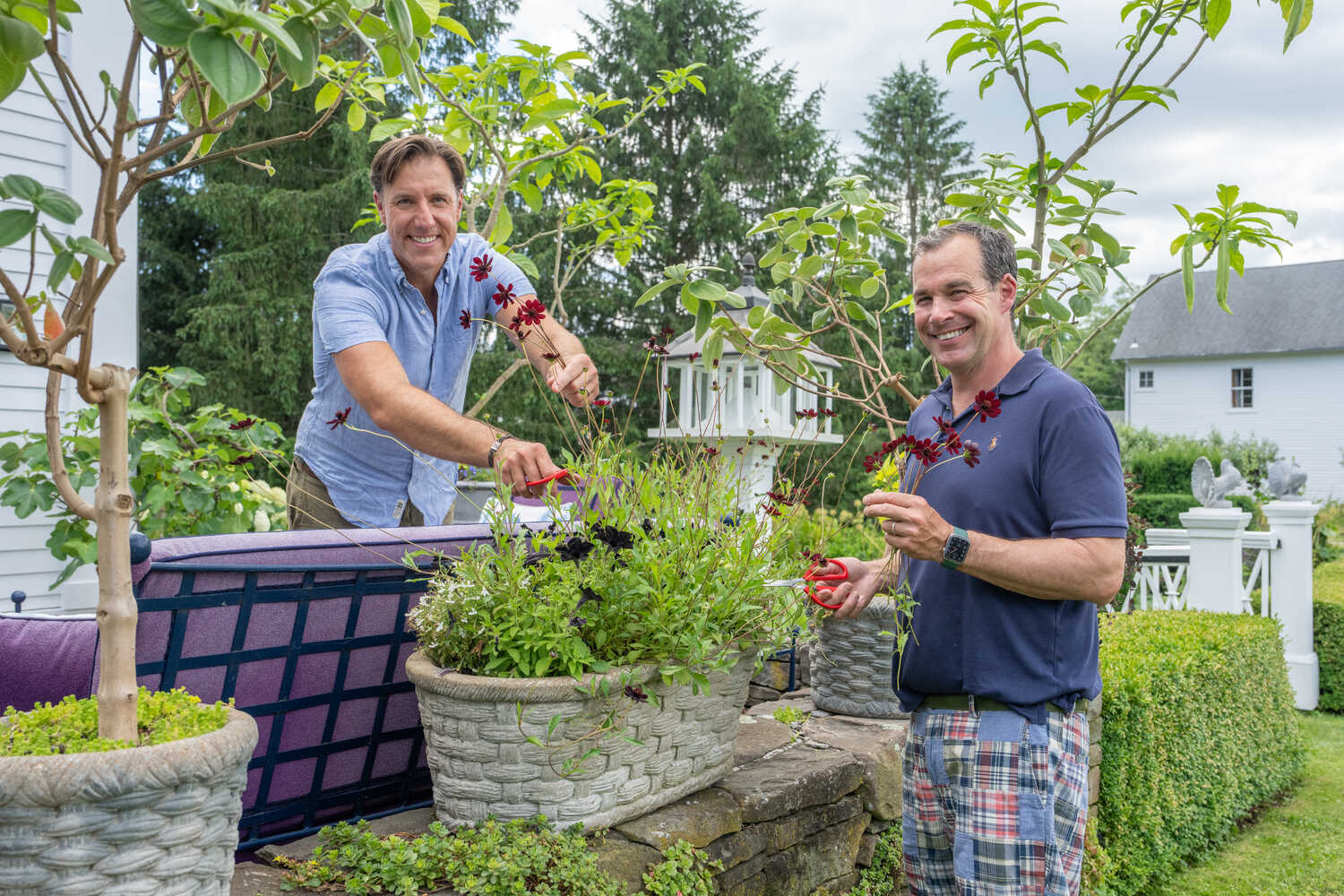 Anthony Bellomo, left, and Christopher Spitzmiller often decorate their house in Millbrook, N.Y., with flowers from the garden. (Here, they cut chocolate cosmos from a container.)