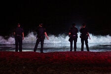 Police officers on the beach at Coney Island in Brooklyn where two teenagers drowned on Friday night.