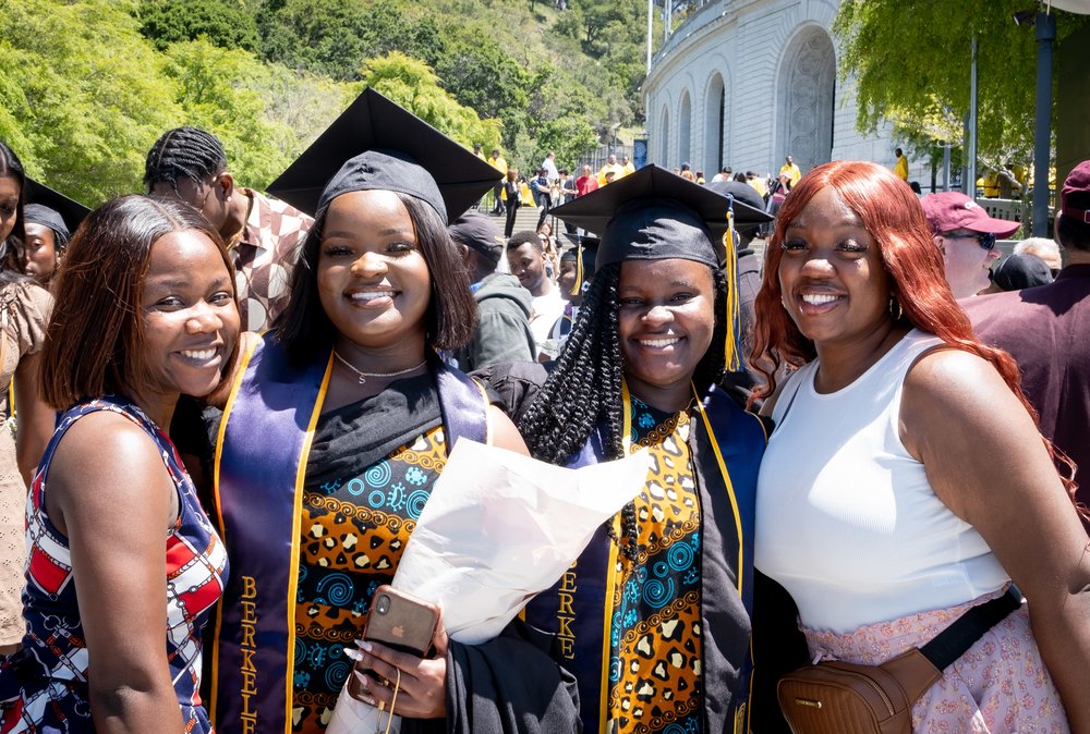 Graduates pose with family at the end of the May 2023 ceremony