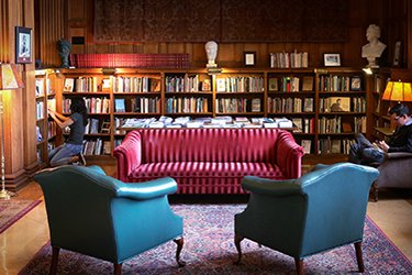 Reading room with comfy furniture. Natural light is lighting up the space.