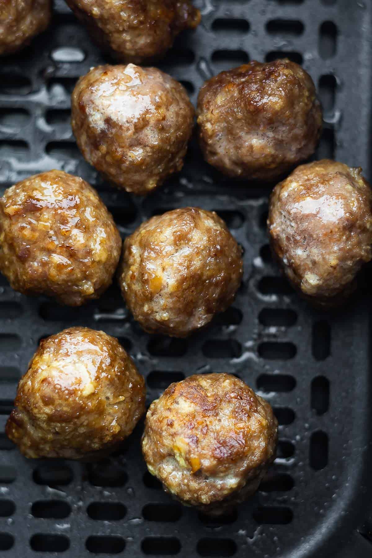 close up shot of meatballs in air fryer basket