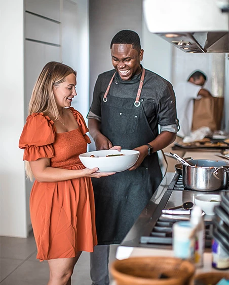 a man and a woman cooking in a kitchen