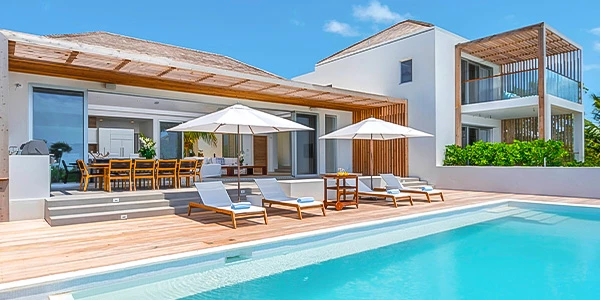 a pool with chairs and umbrellas