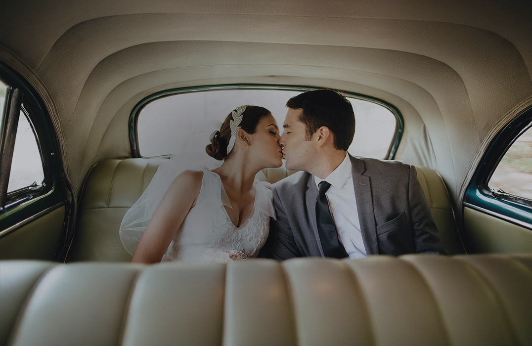 a man and woman kissing in a car