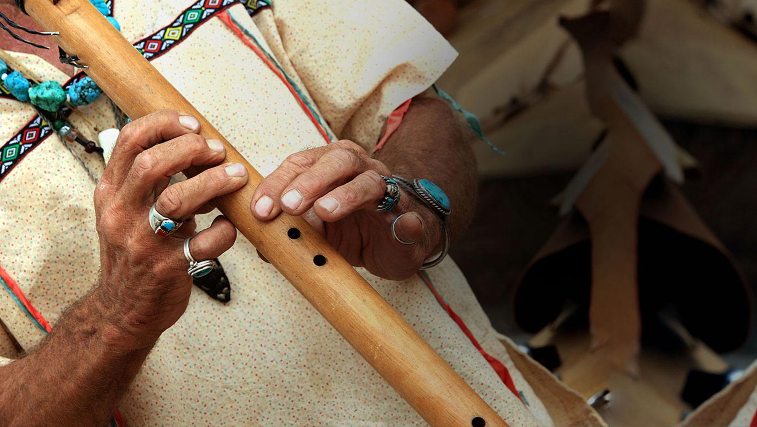 person playing a wooden flute