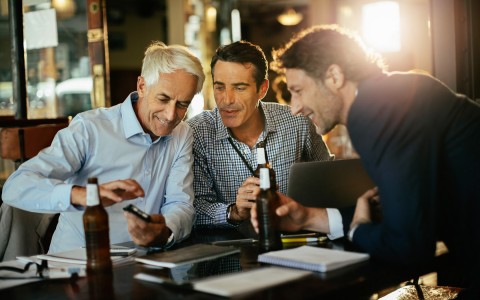 friends at a table looking at documents