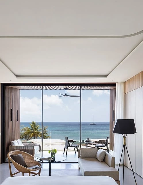 a living room with a view of the ocean