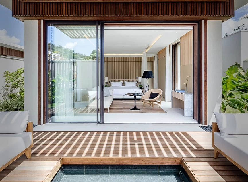 a room with a glass door and a table and chairs