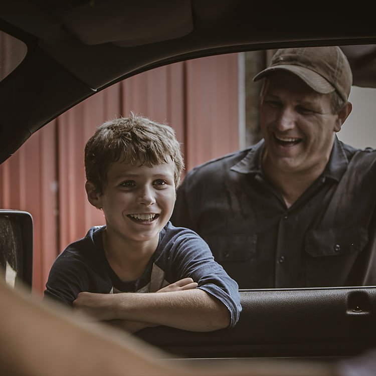 Man and child outside of a vehicle 