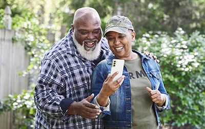 Military couple looking at phone