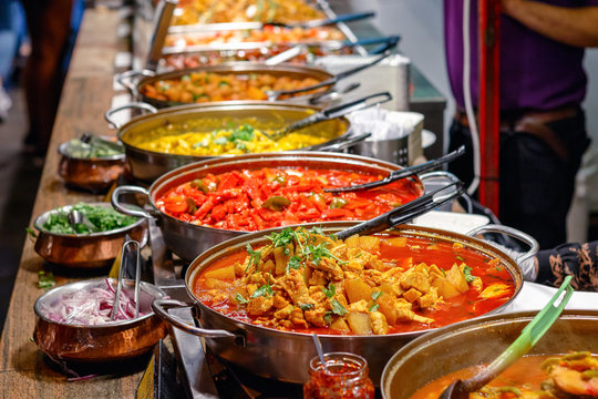 Variety of cooked curries on display at Camden Market in London