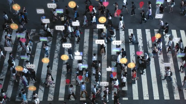 High Angle Shot of a Crowded Pedestrian Crossing in Big City. Augmented Reality of Social Media Signs, Symbols, Location Tracking and Emojis are Added to People. Future Technology Concept.