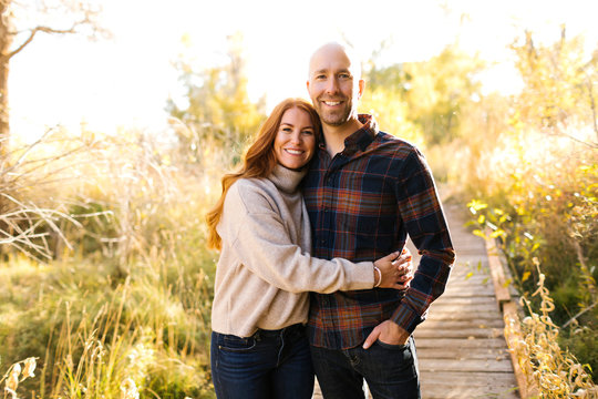 Smiling couple on forest boardwalk