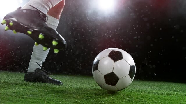 Close-up of Football Player Kicking Soccer Ball, Super Slow Motion at 1000 fps. Filmed on High Speed Cinematic Camera.