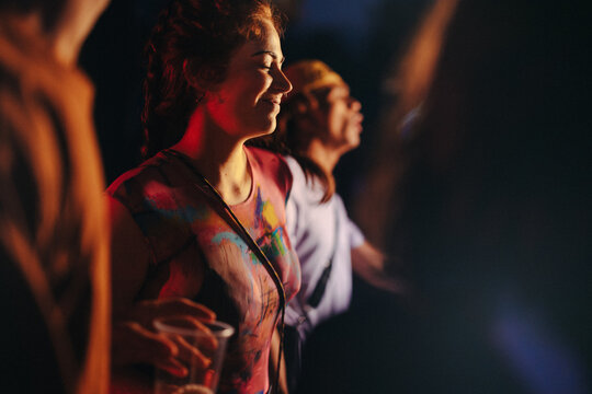 Woman dancing and enjoying herself at a lively music festival