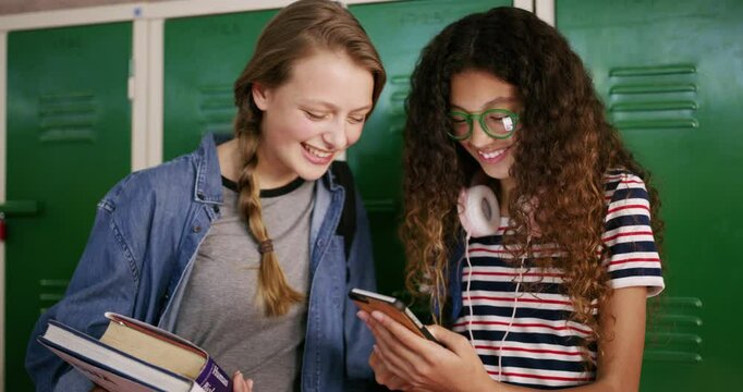 Students, girls and phone at high school locker for social media, funny meme or reading post on internet. Friends, teenager or youth laugh on mobile for chat, e learning and online resources or books