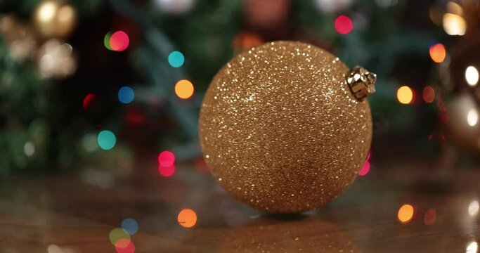 Christmas ball spinning against christmas blur background. Christmas Ornament. Gold christmas balls with bokeh background