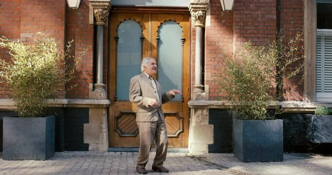 Senior man, dancing and celebration for travel, retirement and freedom in Italy with happy energy and excited with city building background. Elderly person on urban street to dance and celebrate