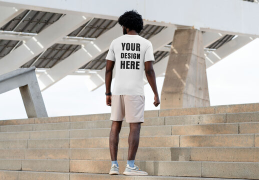 Mockup of man wearing customizable t-shirt on steps