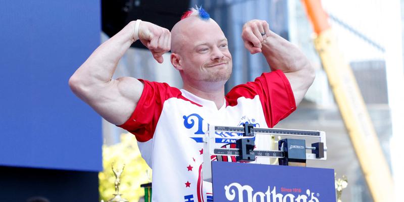 Nick Wehry stands on the scale at the 108th Nathan's Famous Fourth of July International Hot Dog Eating Contest
