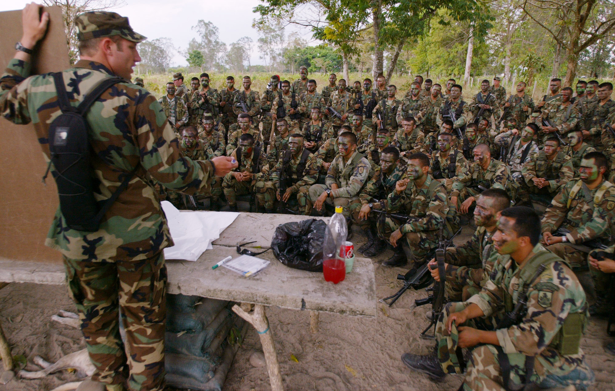 --FILE-- This Feb. 7, 2003 file photo shows a U.S. Special Forces soldier, left, training Colombian troops at a military base in Saravena, Arauca state. Hundreds of troops are based in Colombia to help local forces battling drug traffickers and leftist rebels. (AP Photo/Ricardo Mazalan, File)