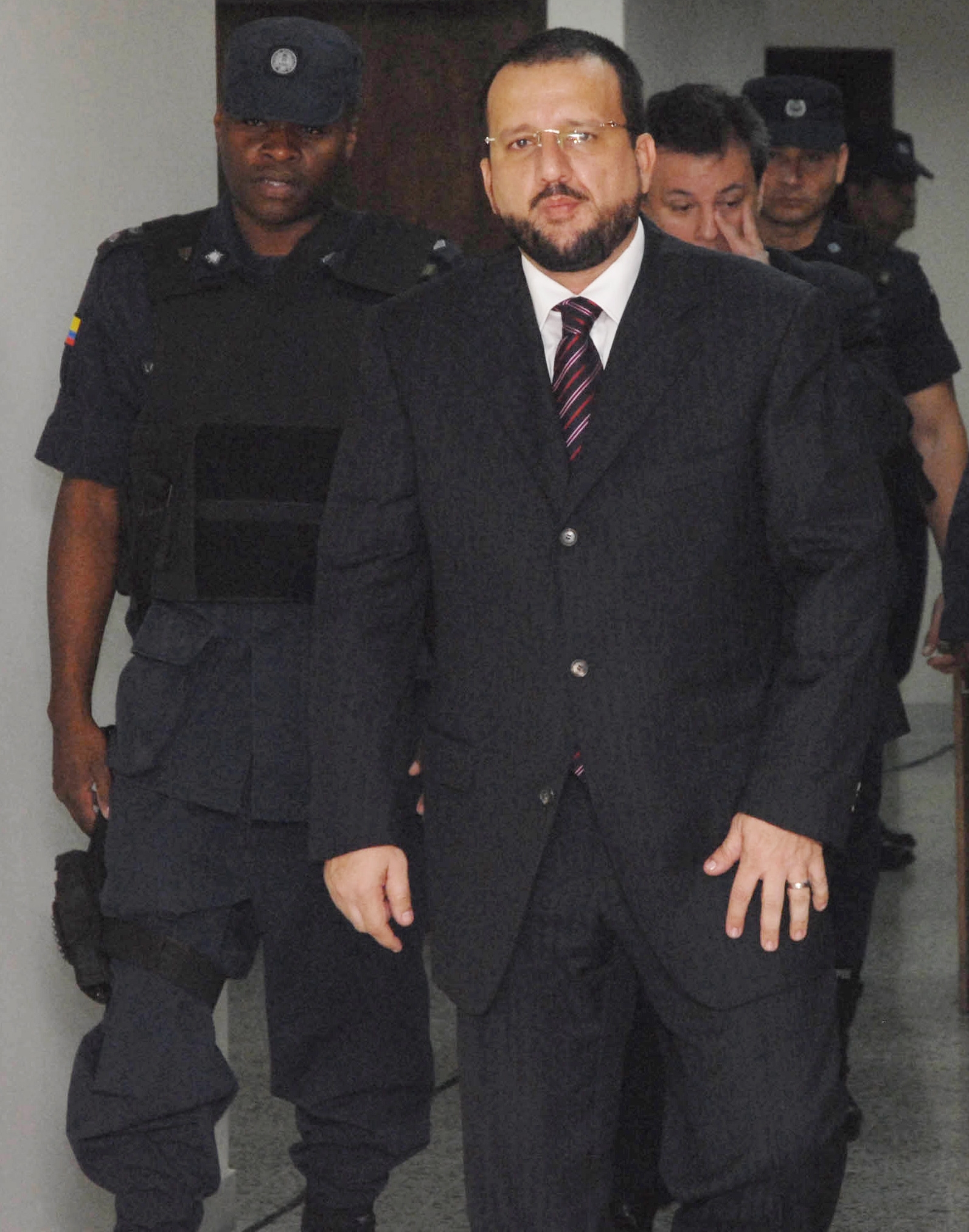 Former paramilitary leader Carlos Mario Jimenez arrives for a court hearing in Medellin, Colombia, Tuesday, June 12, 2007. Under a peace deal with the government, Jimenez and other members of the United Self-Defense Forces of Colombia, AUC, must give detailed confessions of their alleged participation in crimes. (AP Photo/Luis Benavides, Pool)