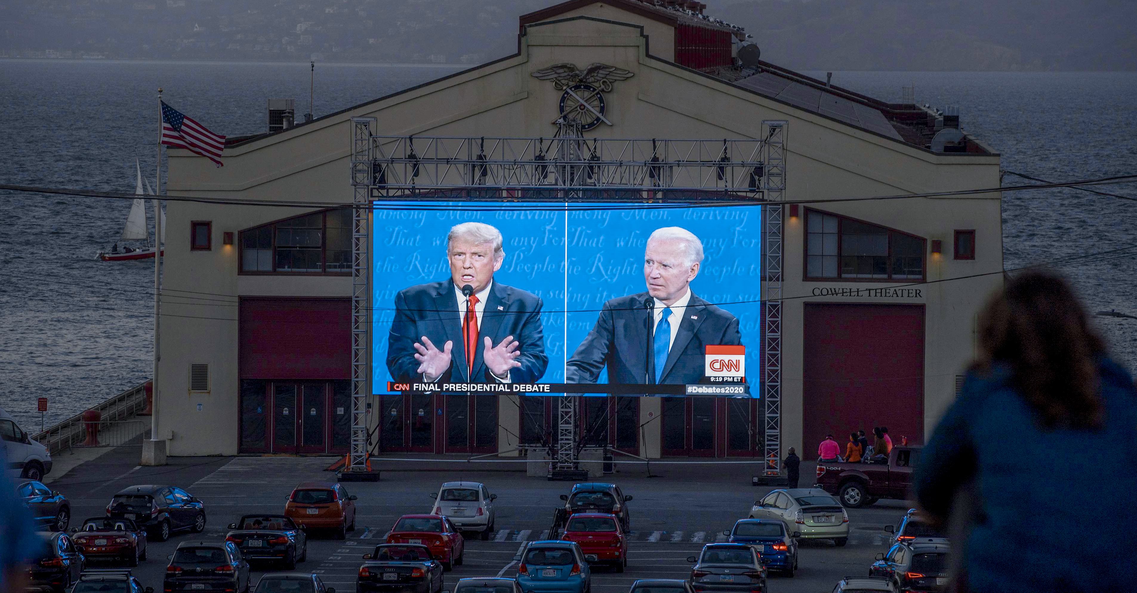 SAN FRANCISCO, CALIFORNIA - OCTOBER 22: People watch the final U.S. presidential debate between President Donald Trump and Democratic candidate Joe Biden outside Cowell Theater on October 22, 2020 in San Francisco, California. (Photo by Liu Guanguan/China News Service via Getty Images)