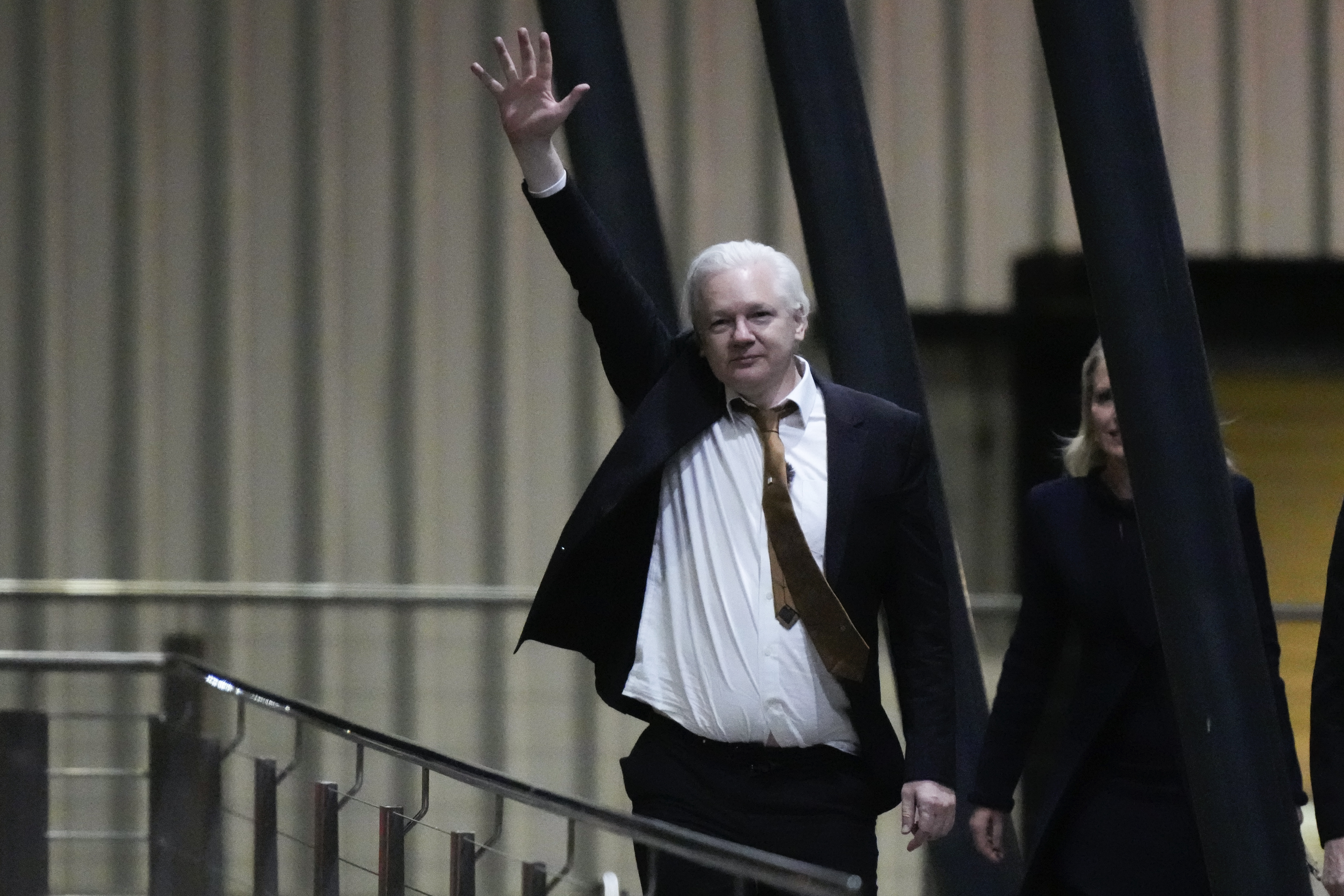 WikiLeaks founder Julian Assange waves after landing at RAAF air base Fairbairn in Canberra, Australia, Wednesday, June 26 2024.