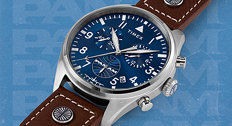 Blue dial watch with 3 sub dials in a steel case on a brown strap. the watch is laid across a light blue background