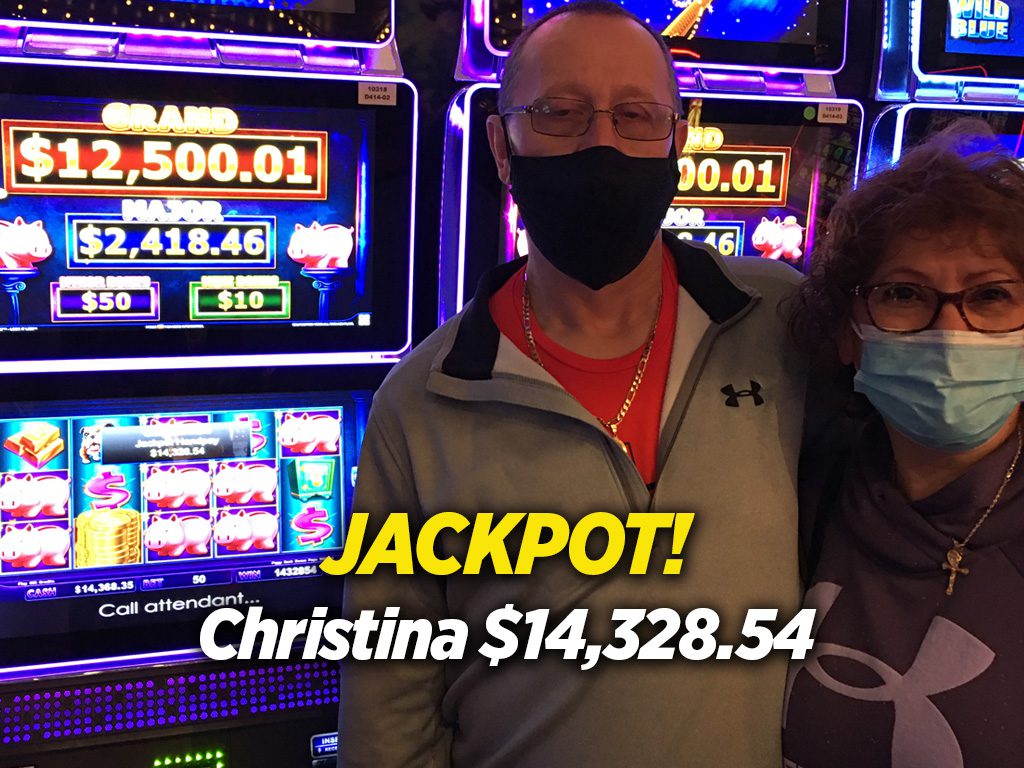 A man and woman standing in front of slot machines.