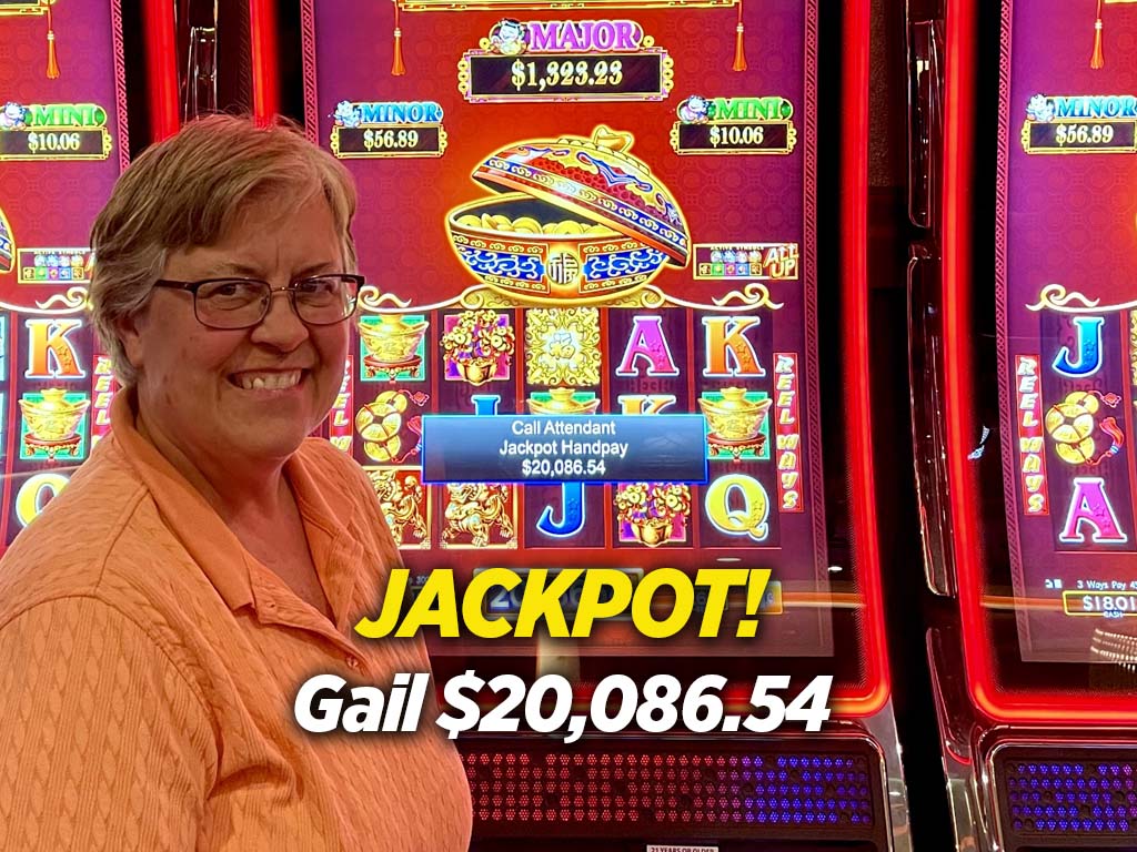 A woman standing in front of a slot machine.