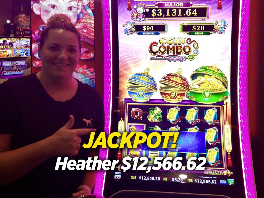 A woman standing in front of a slot machine.