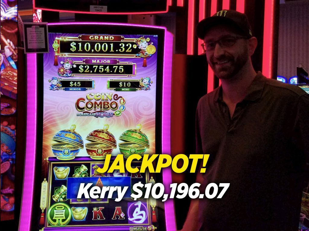 A man standing in front of a slot machine.