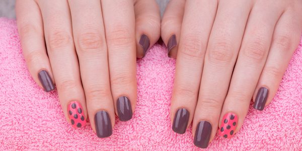 A woman with her hands on top of a pink towel.