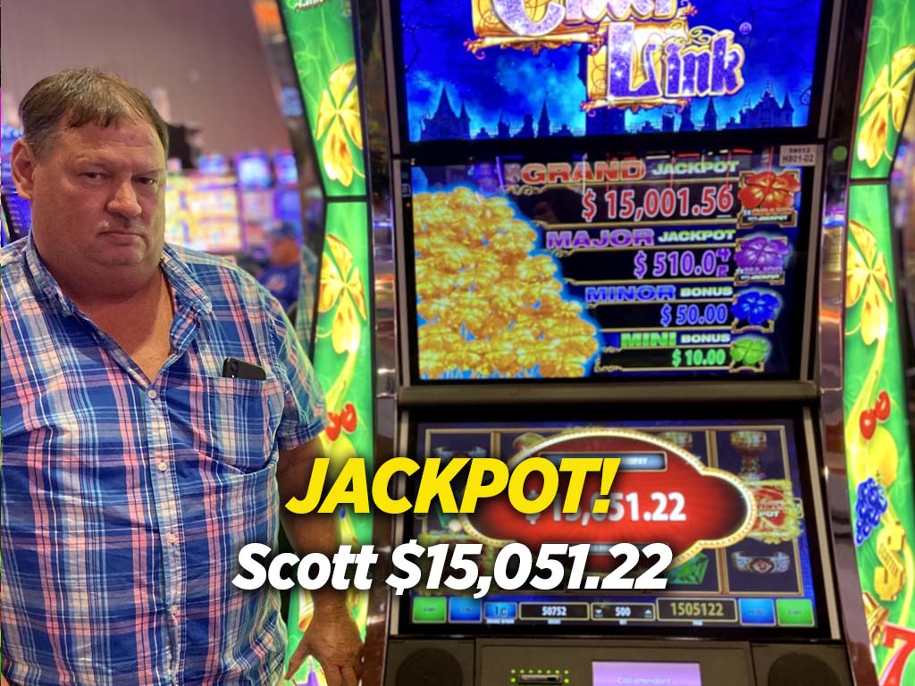 A man standing in front of a slot machine.