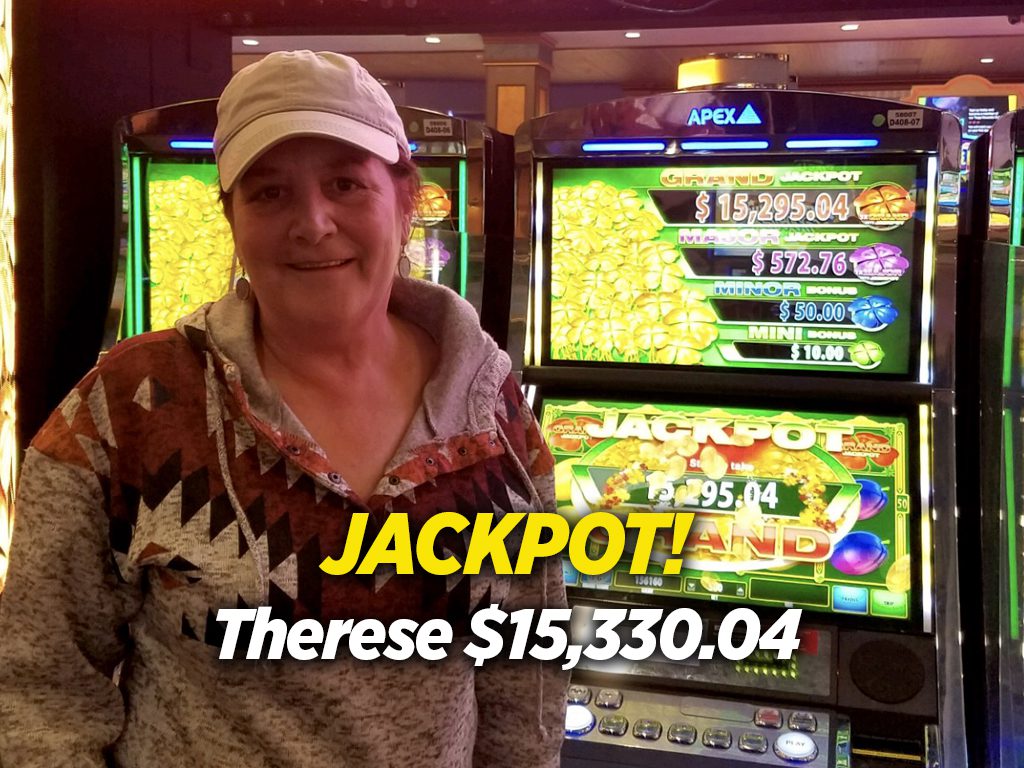 A woman standing in front of a slot machine.