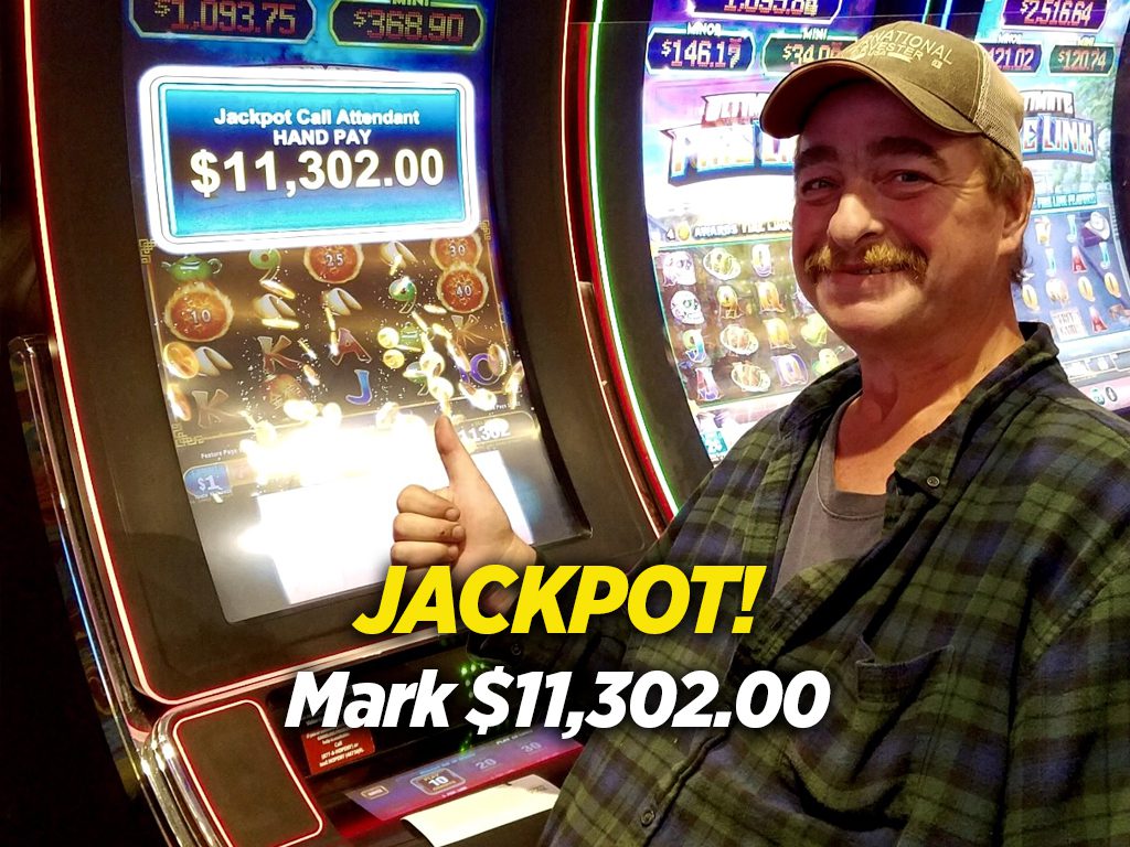 A man standing in front of a slot machine.