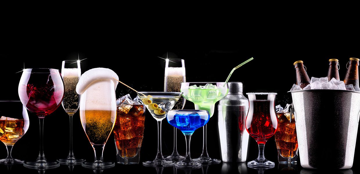 A group of different types of drinks in glasses.