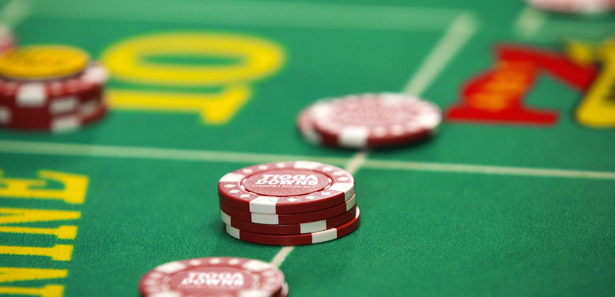 A close up of some red and white chips on a green table