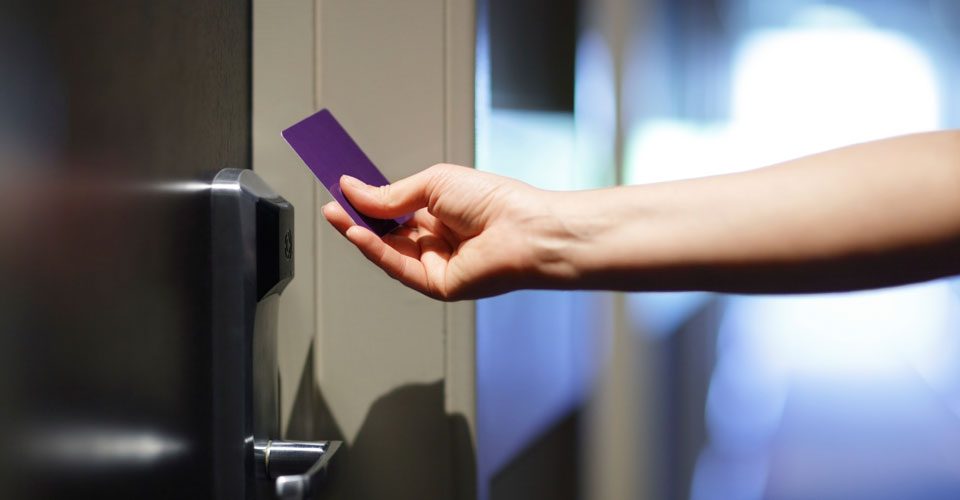 A person holding a purple card in their hand.