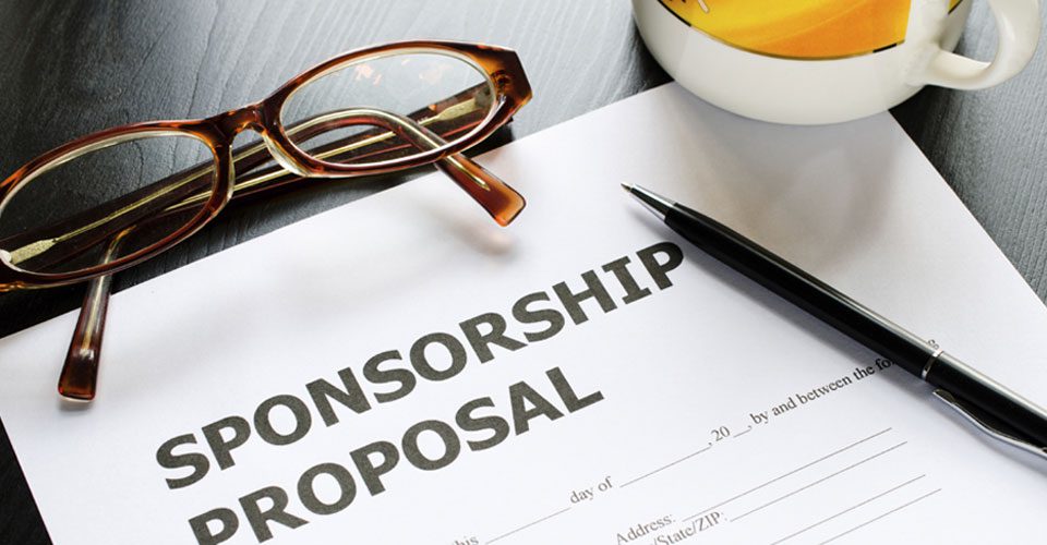 A sponsorship proposal is on top of the table.