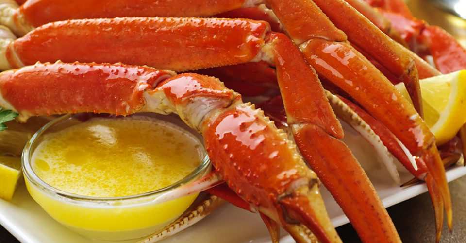 A close up of crab legs and a bowl