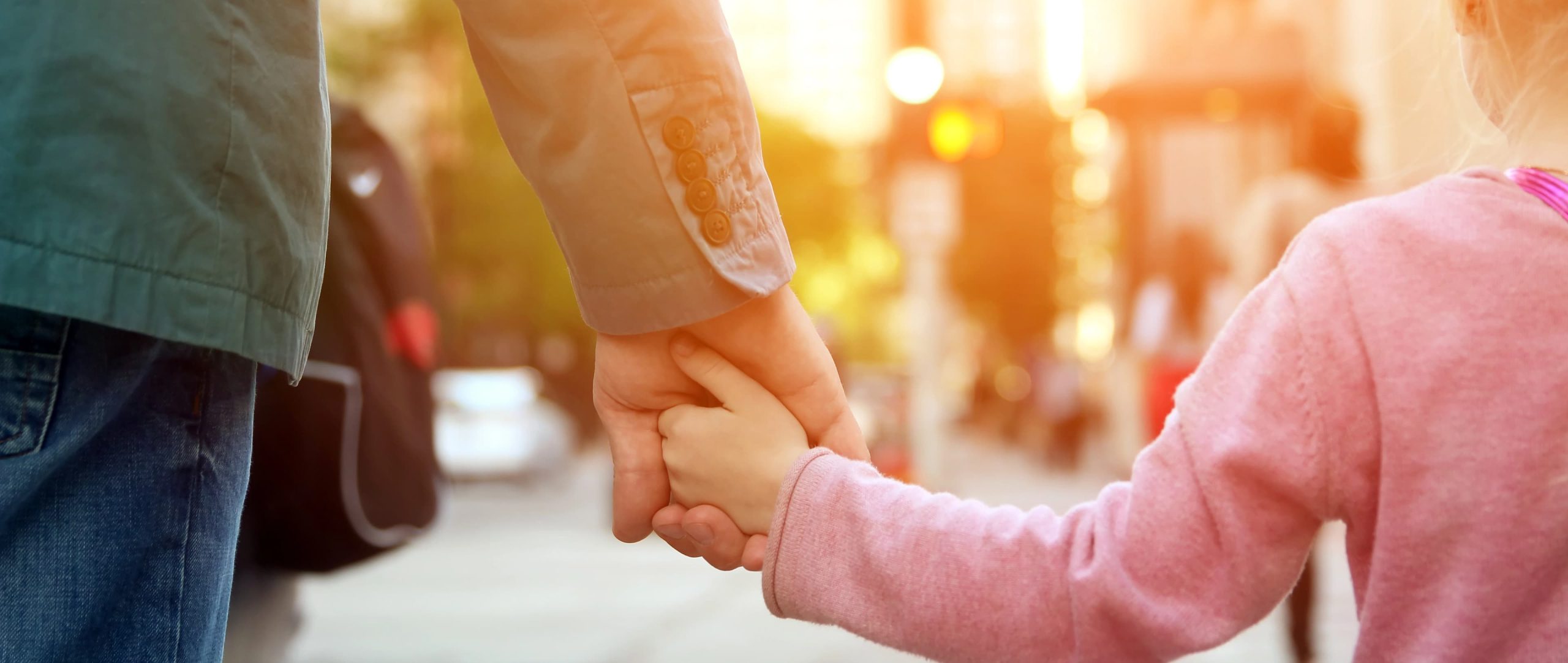 an adult walking with a small child to support the vision of Nashville