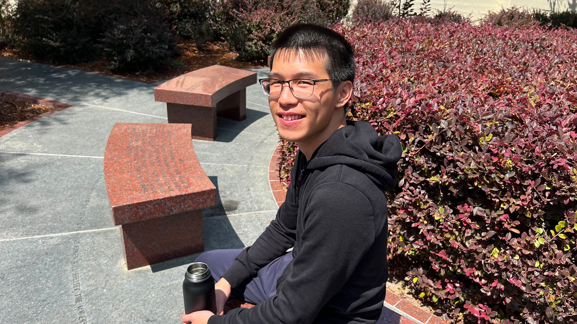 Jonathan Tam sitting on a bench