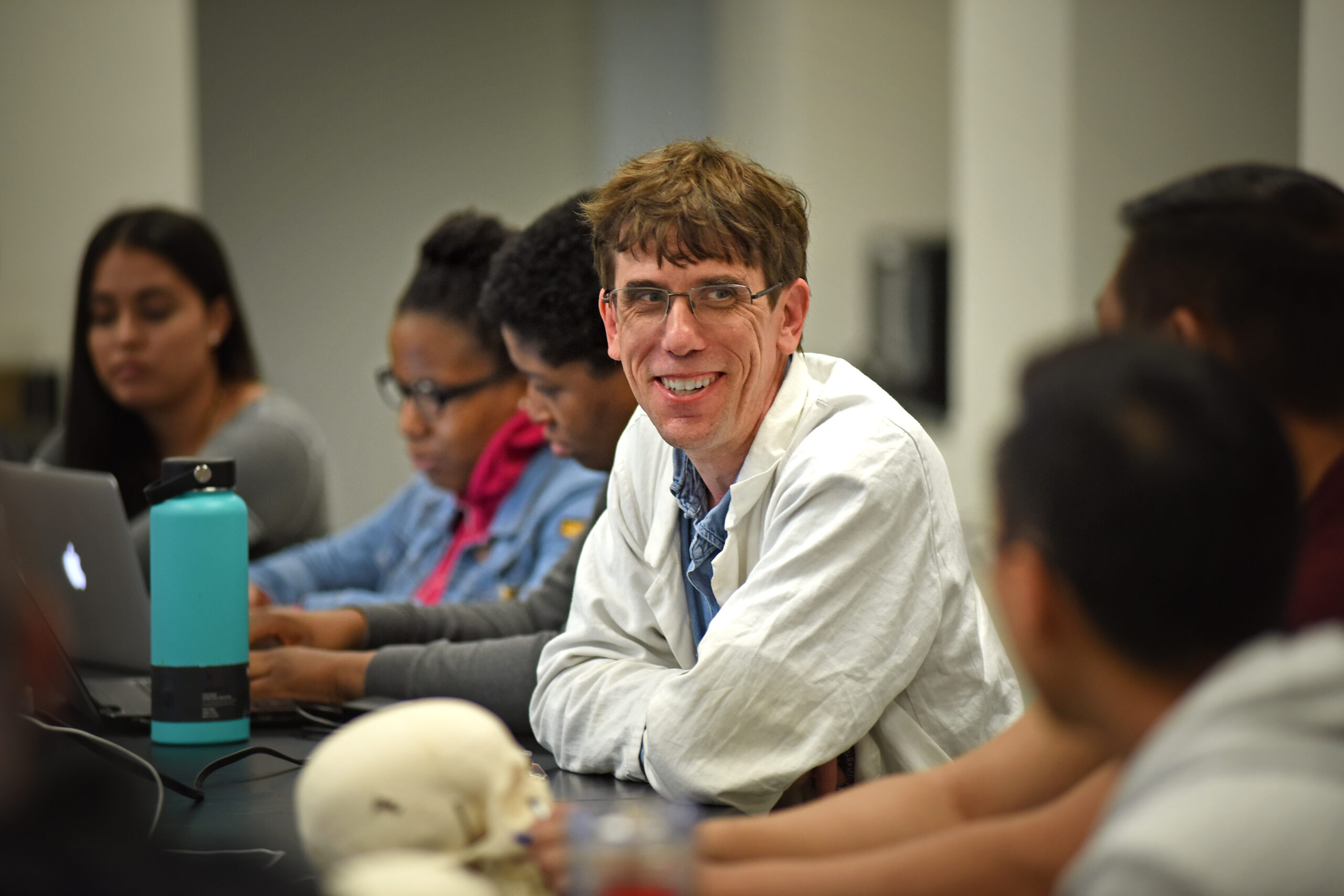 Dr. Paul Mozdziak chats with students before a class presentation in his Scott Hall lab.