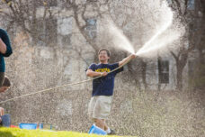 A student sprays water in celebration of Songkran, the Thai new year.