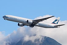 Aircraft takeoff. Side view of aircraft ascending, with landing gear doors open.